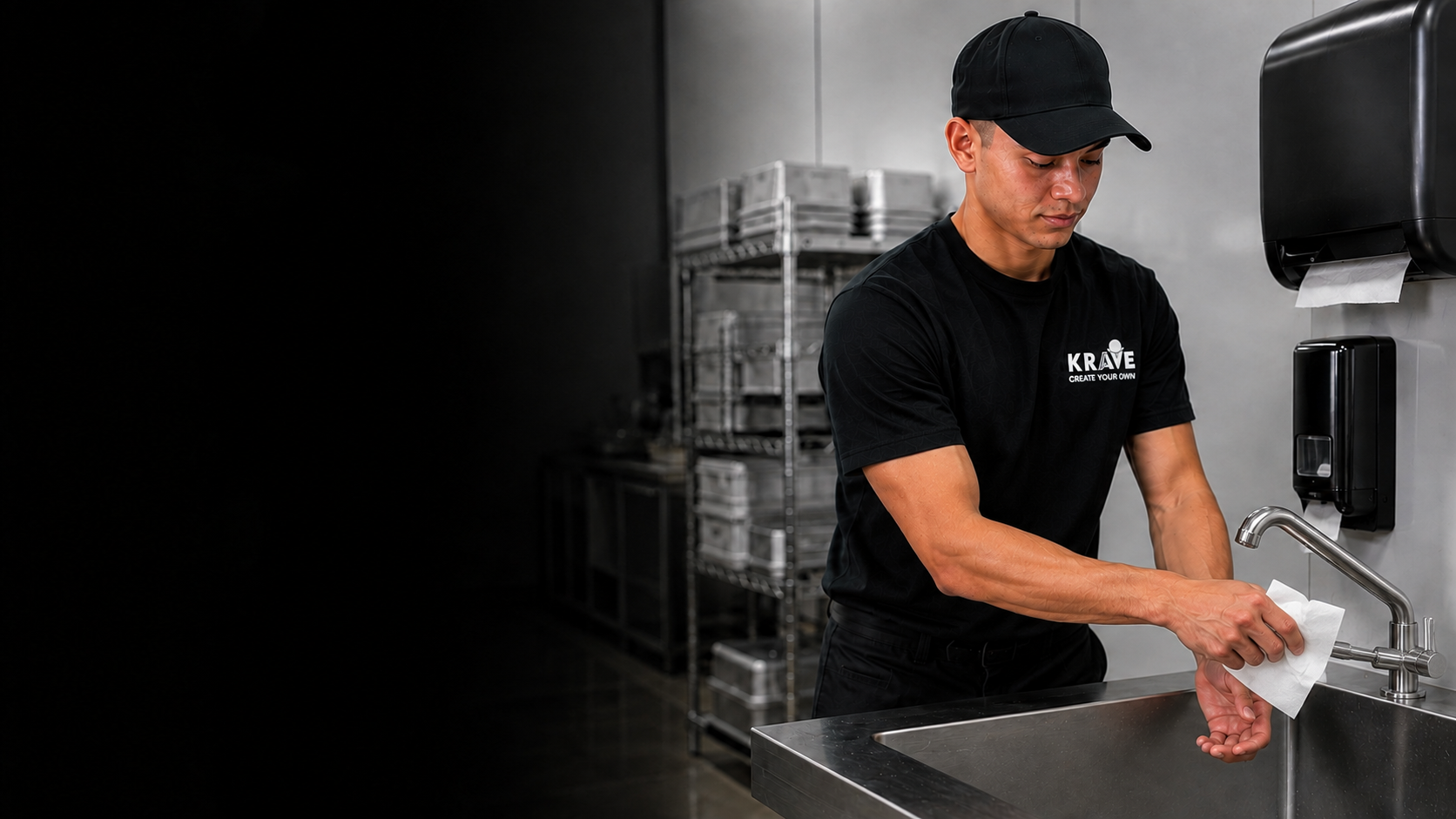 A Krave employee using a paper towel as a barrier to turn off a manual faucet