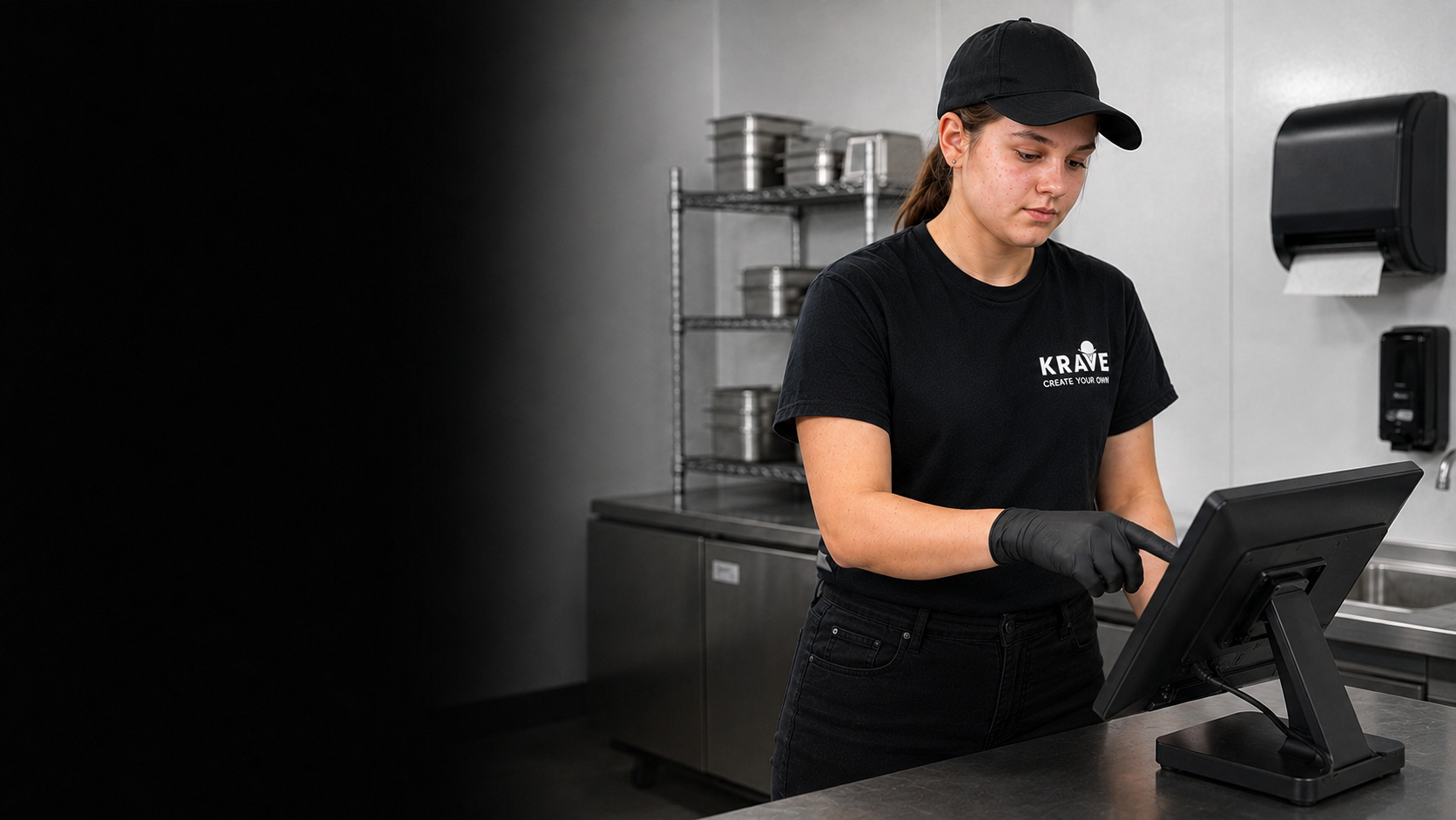 A teenage Krave employee touching a POS screen while wearing food-service gloves